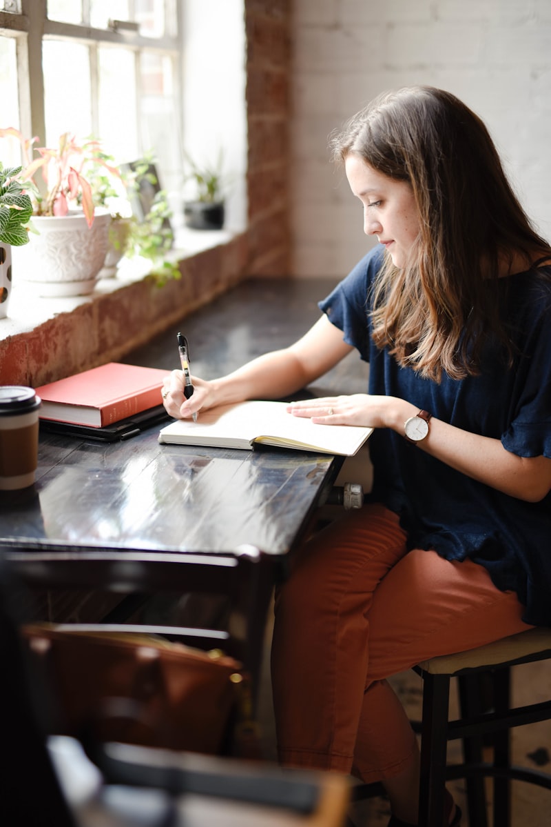 Student writing focused at desk — discipline and structure